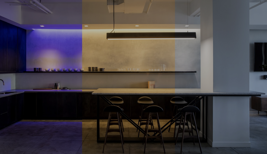 A luxury kitchen is illuminated by different hues of Ketra lighting.